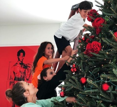 Jlo and her partner Rodriquez decorate Christmas tree with children