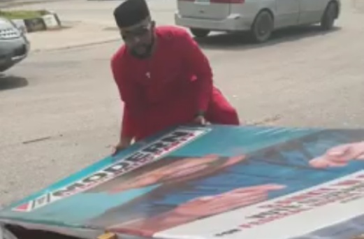 Bankole Wellington picks up his damaged billboards