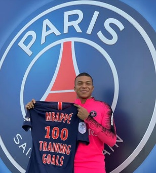 Mbappe presented with a jersey for reaching 100 goals in training